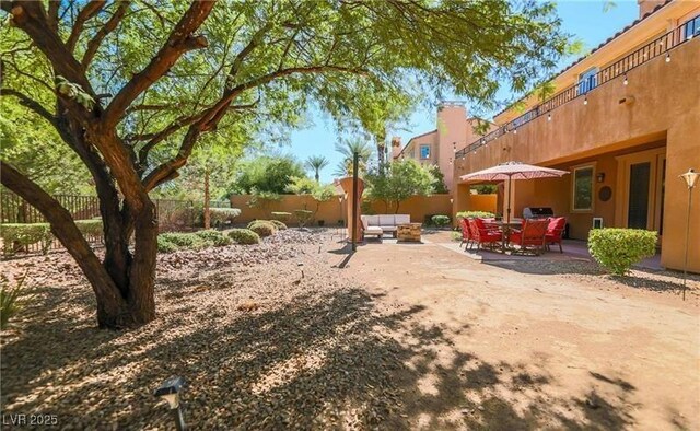 view of yard with a fenced backyard, an outdoor living space, and a patio area