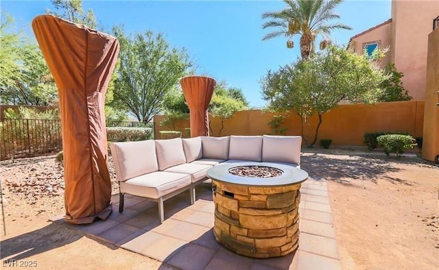 view of patio / terrace featuring an outdoor living space with a fire pit and a fenced backyard