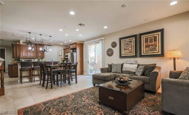 living area featuring visible vents, recessed lighting, and light tile patterned floors