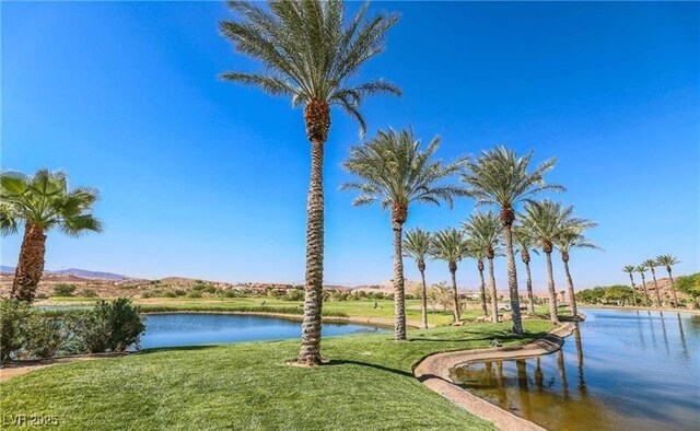 surrounding community featuring a yard and a water view