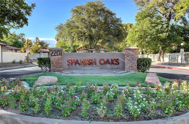 community / neighborhood sign with fence