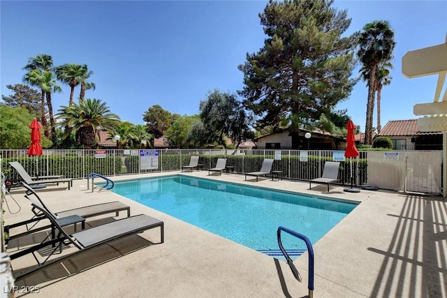 community pool featuring fence and a patio