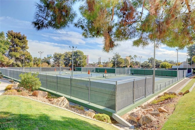 view of tennis court featuring fence