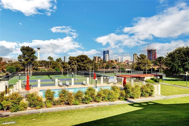 surrounding community with a tennis court