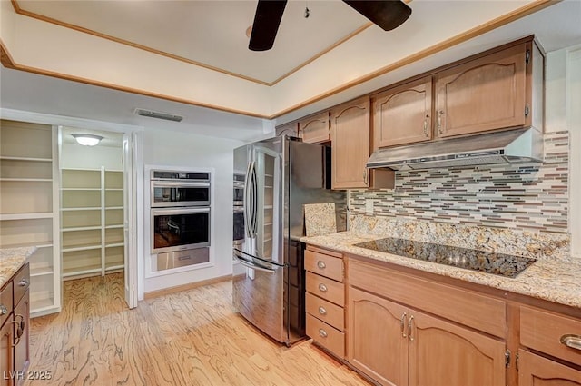 kitchen with appliances with stainless steel finishes, under cabinet range hood, ceiling fan, and light wood-style flooring