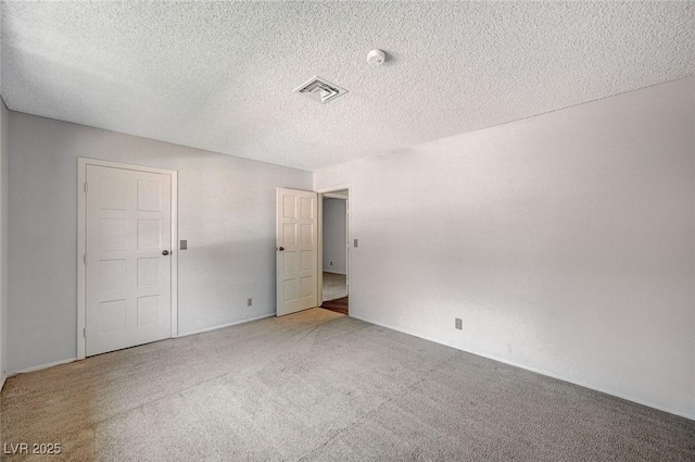 unfurnished bedroom featuring carpet flooring and a textured ceiling