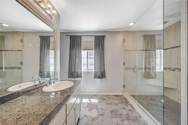 bathroom with baseboards, a shower stall, vanity, and recessed lighting