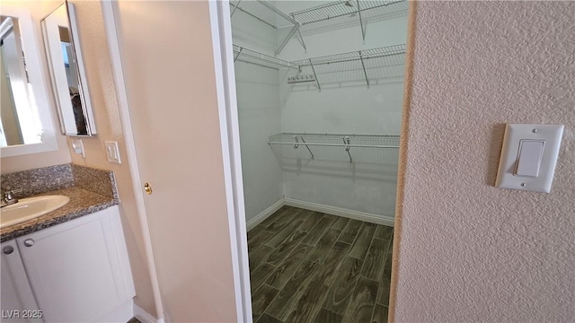 83 Rock Run St, Las Vegas, NV 89148 - walk in closet with dark wood-type flooring and a sink