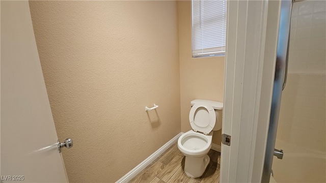 83 Rock Run St, Las Vegas, NV 89148 - bathroom featuring toilet, a textured wall, wood finished floors, and baseboards