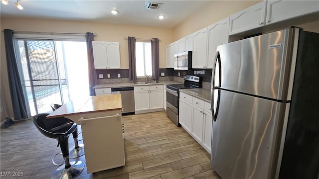 83 Rock Run St, Las Vegas, NV 89148 - kitchen featuring light wood finished floors, visible vents, appliances with stainless steel finishes, and a sink