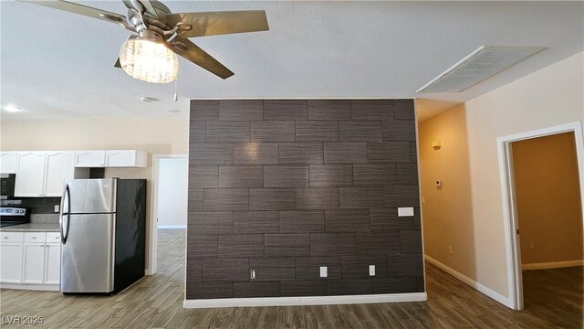 83 Rock Run St, Las Vegas, NV 89148 - kitchen featuring white cabinets, freestanding refrigerator, light wood-style flooring, and a ceiling fan