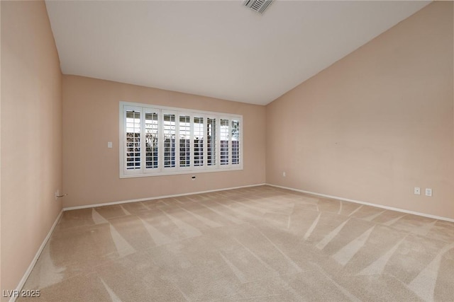 spare room featuring baseboards, carpet, lofted ceiling, and visible vents