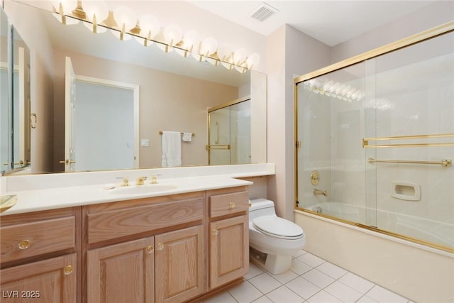 full bathroom with vanity, toilet, tile patterned floors, visible vents, and bath / shower combo with glass door