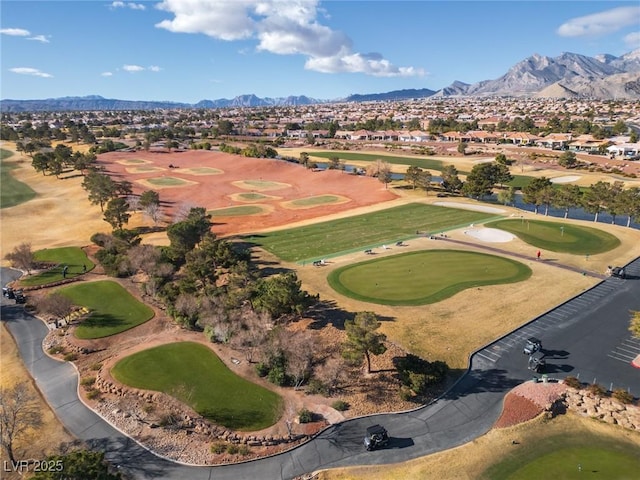 aerial view featuring view of golf course, a residential view, and a mountain view