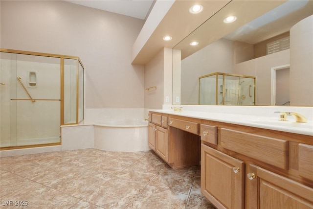 bathroom with double vanity, recessed lighting, a bath, a sink, and a stall shower