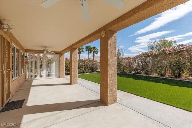view of patio / terrace with a ceiling fan and fence