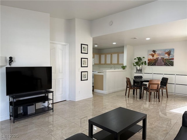 living room featuring baseboards, recessed lighting, and marble finish floor