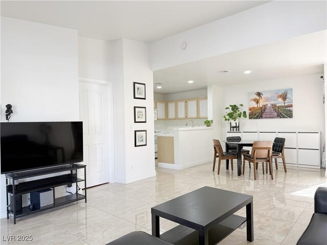 living area with baseboards, recessed lighting, and marble finish floor