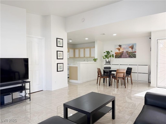 living area with recessed lighting, baseboards, and marble finish floor
