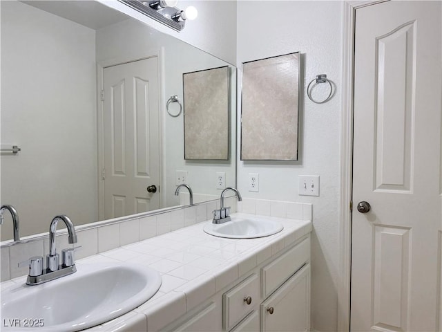 bathroom featuring double vanity and a sink