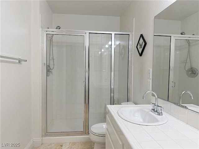 bathroom with vanity, toilet, and a shower stall