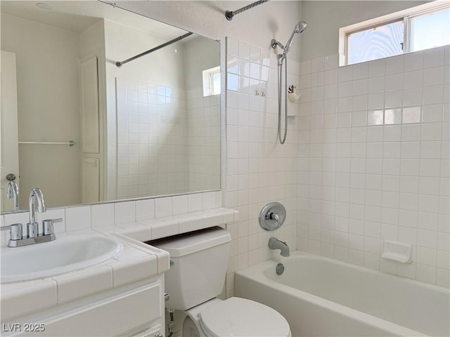 bathroom featuring shower / washtub combination, vanity, toilet, and a wealth of natural light