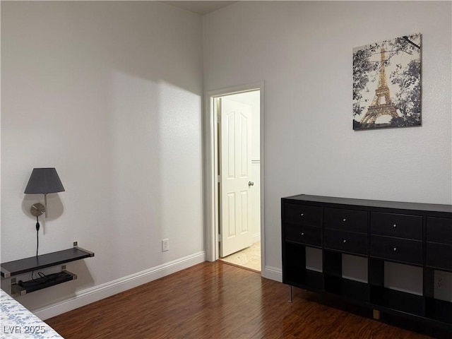 unfurnished bedroom with baseboards and wood finished floors