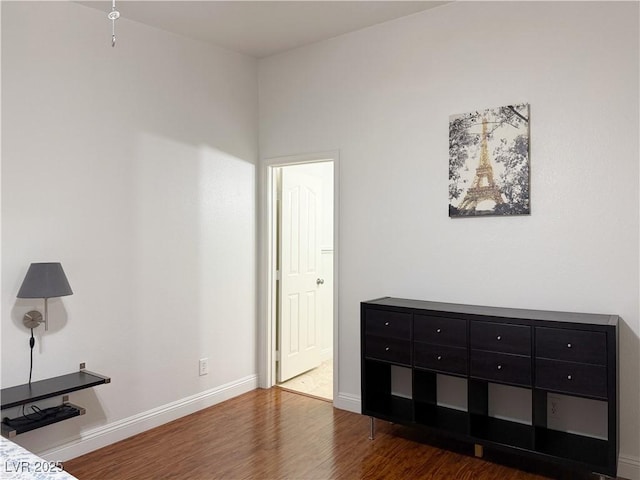 unfurnished bedroom featuring baseboards and wood finished floors