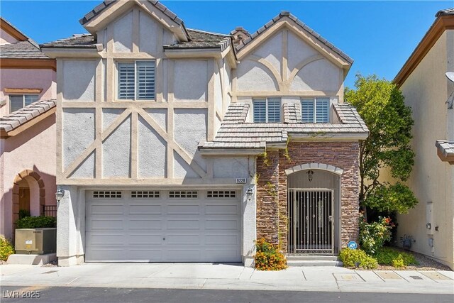 view of front of home featuring stucco siding, driveway, stone siding, and a garage