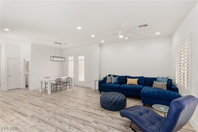 living area featuring visible vents, baseboards, light wood-type flooring, recessed lighting, and a ceiling fan