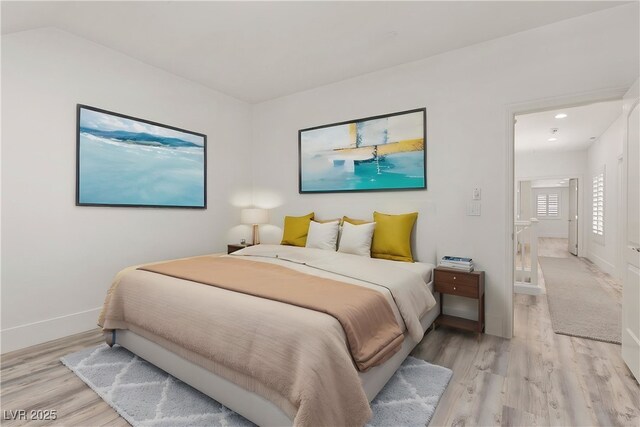 bedroom with baseboards, recessed lighting, and light wood-style floors