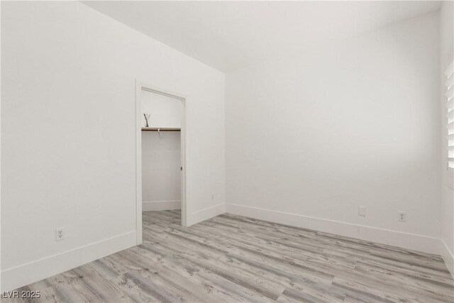 unfurnished room featuring light wood-style floors and baseboards