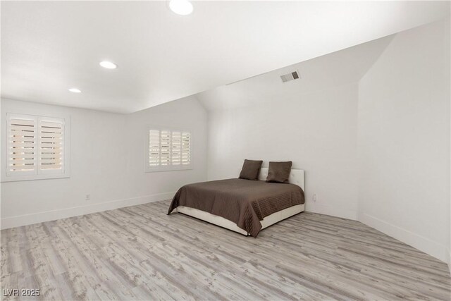 bedroom with baseboards, visible vents, wood finished floors, and recessed lighting