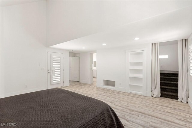 bedroom featuring baseboards, recessed lighting, ensuite bath, and light wood-style floors