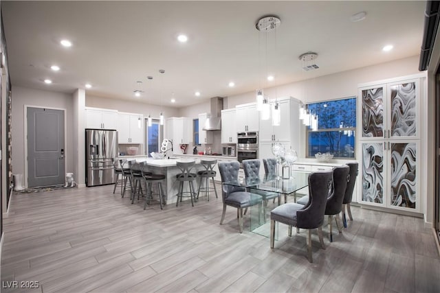 dining area featuring recessed lighting, visible vents, and light wood-type flooring