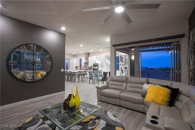 living room with a ceiling fan, wood finished floors, and recessed lighting
