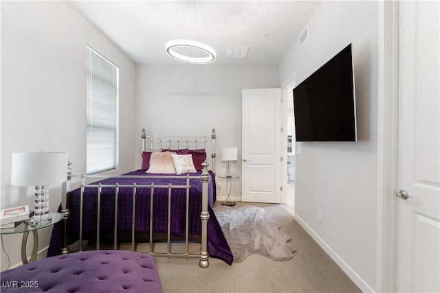 carpeted bedroom featuring baseboards and visible vents
