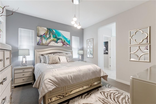bedroom featuring carpet floors and baseboards
