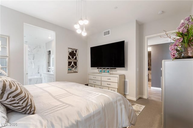 bedroom with visible vents, baseboards, light carpet, and connected bathroom