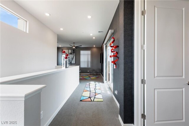 hall with baseboards, light carpet, visible vents, and recessed lighting