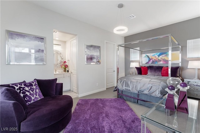 bedroom featuring visible vents, baseboards, connected bathroom, and light colored carpet