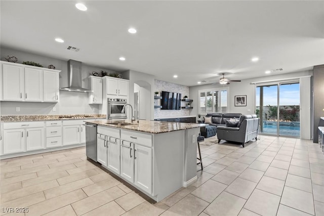 5852 Ireland Ridge Ct, Las Vegas, NV 89149 - kitchen featuring wall chimney exhaust hood, appliances with stainless steel finishes, a sink, recessed lighting, and ceiling fan
