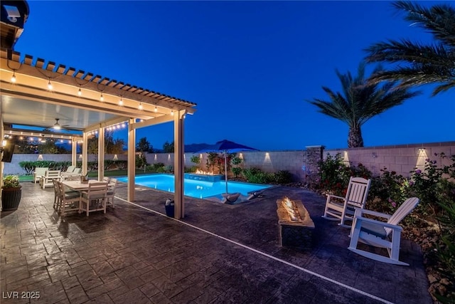 5852 Ireland Ridge Ct, Las Vegas, NV 89149 - pool at twilight with a patio area, a fenced backyard, and a pergola