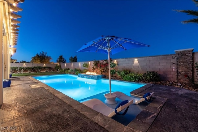 5852 Ireland Ridge Ct, Las Vegas, NV 89149 - pool at night with a fenced backyard and a patio area