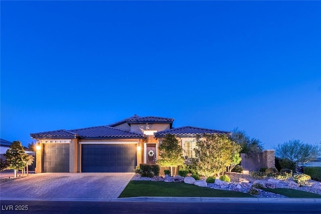 5852 Ireland Ridge Ct, Las Vegas, NV 89149 - view of front facade with a garage, a tile roof, stucco siding, and decorative driveway