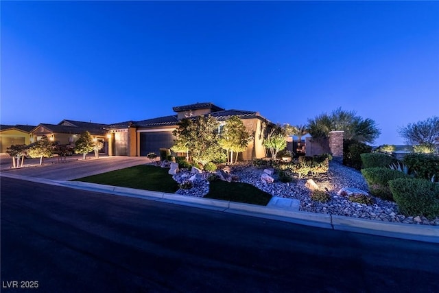 5852 Ireland Ridge Ct, Las Vegas, NV 89149 - view of front facade featuring an attached garage, concrete driveway, a tile roof, and stucco siding