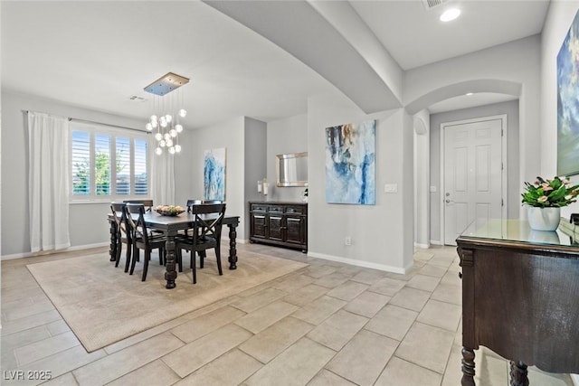 5852 Ireland Ridge Ct, Las Vegas, NV 89149 - dining room featuring arched walkways, baseboards, a chandelier, and light tile patterned floors