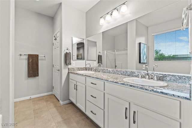 5852 Ireland Ridge Ct, Las Vegas, NV 89149 - bathroom with double vanity, baseboards, a shower with shower door, and tile patterned flooring