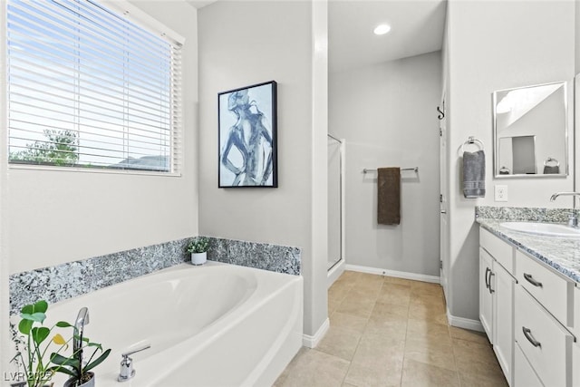 5852 Ireland Ridge Ct, Las Vegas, NV 89149 - bathroom featuring a garden tub, vanity, healthy amount of natural light, and a stall shower
