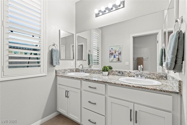 5852 Ireland Ridge Ct, Las Vegas, NV 89149 - bathroom with double vanity, tile patterned floors, and baseboards